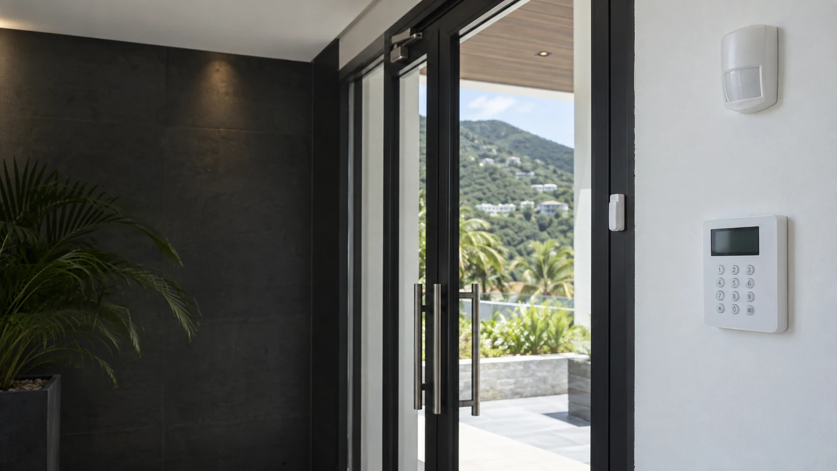 Illustrative Caribbean entrance with an alarm keypad, motion detector and door contact